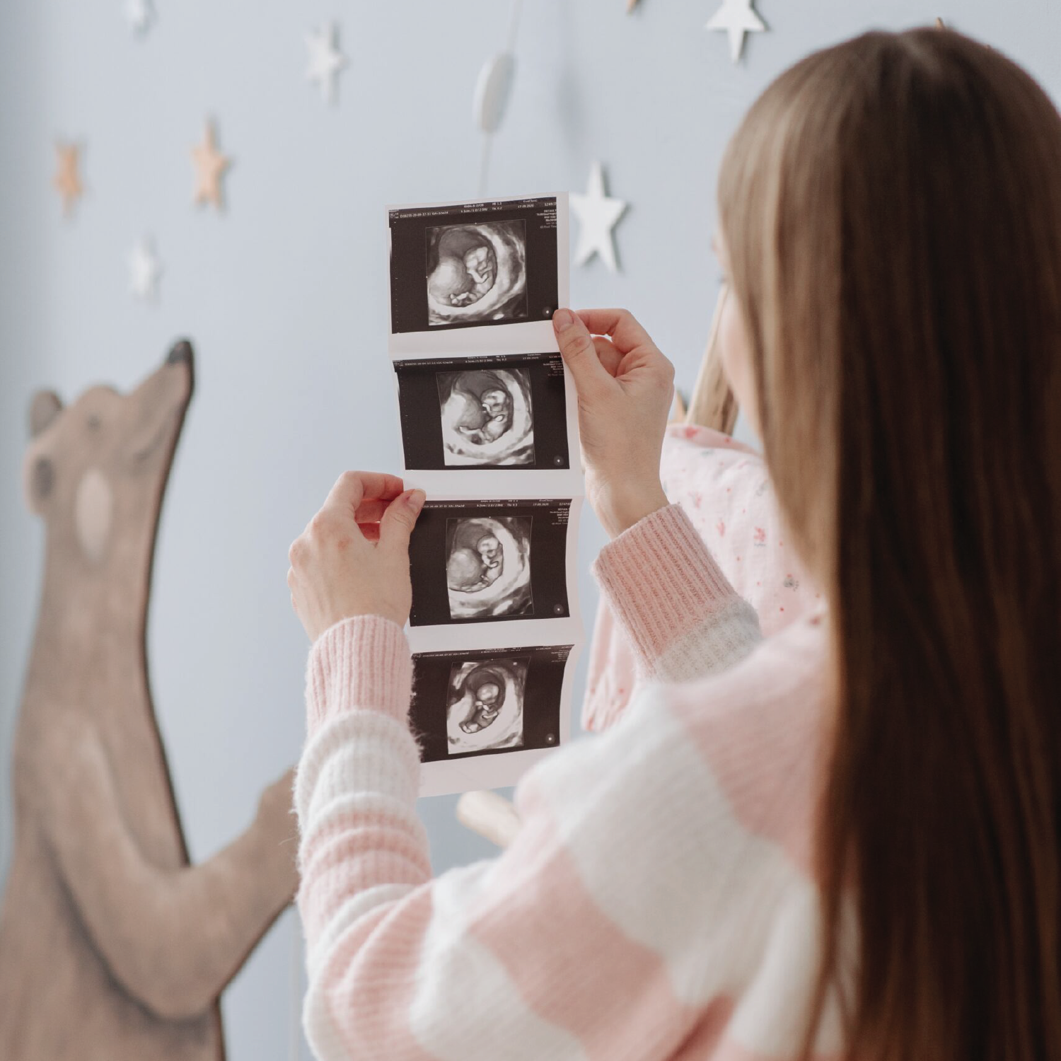 A pregnant mom watching her scan pictures
