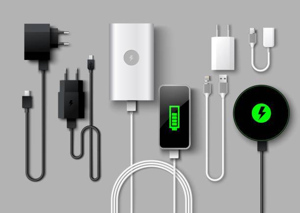 "Various types of chargers, including USB-C, Lightning, and wireless charging pads, neatly arranged on a wooden surface."