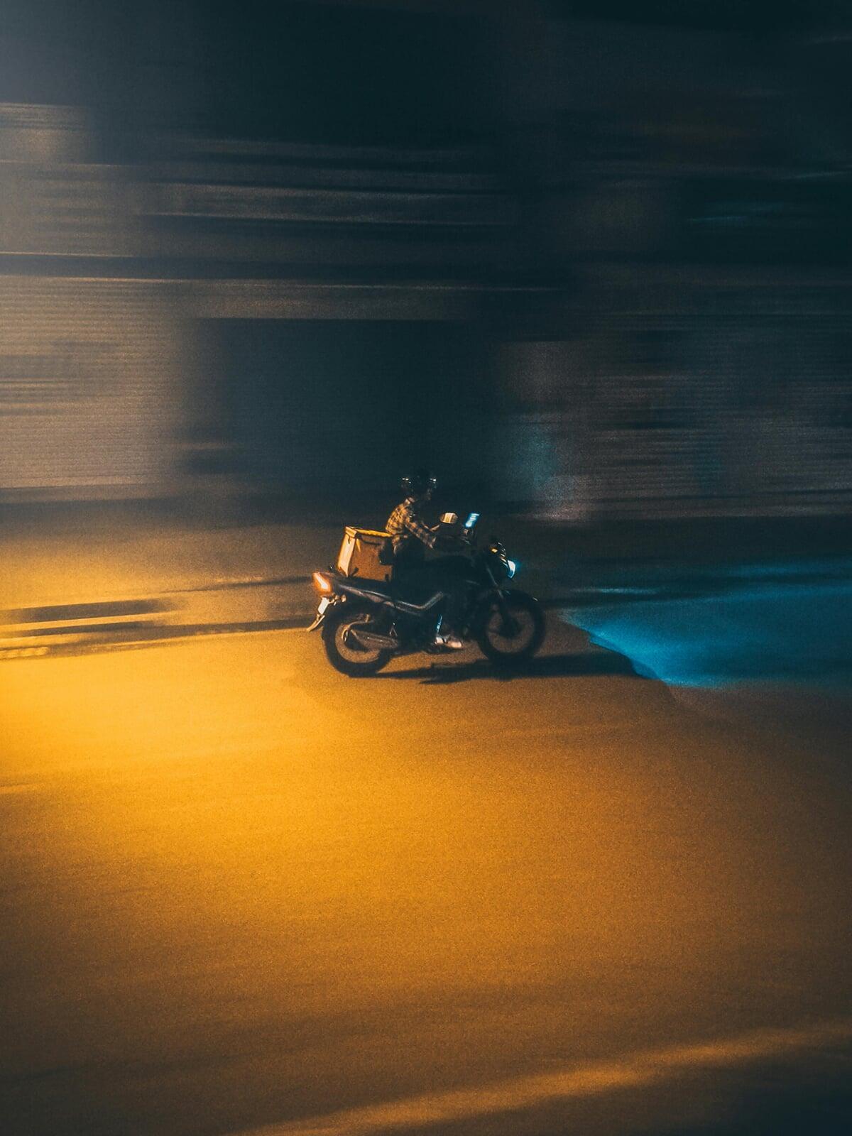 A delivery boy rushing towards location in night