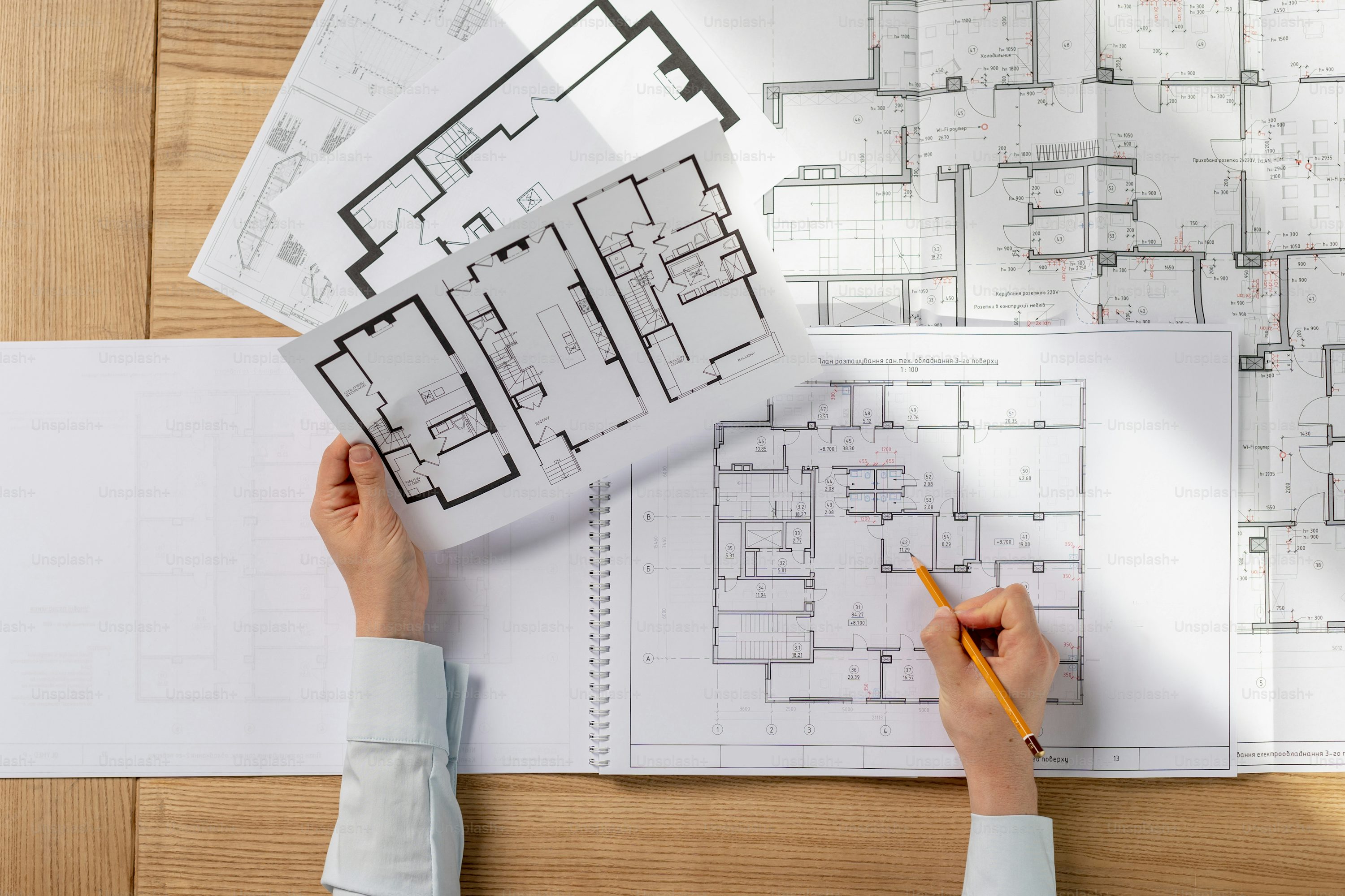 Architect reviewing house plans with client, offering consultancy for home design, renovation, and construction - Homizon Architect Services