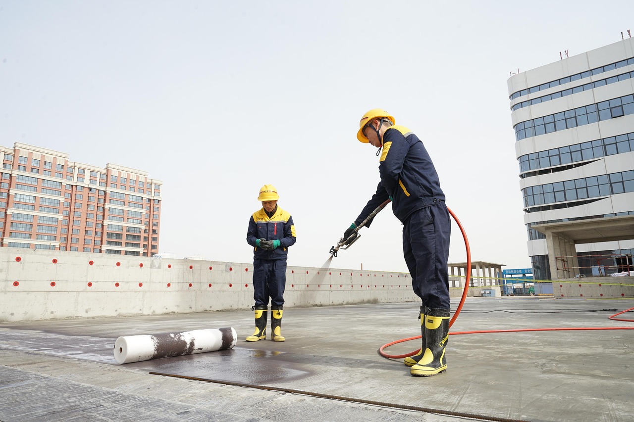 Workers applying chemical waterproofing on terrace – Homizon leakage protection service