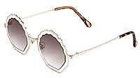 Soigné Female Medium Round Sunglasses. Transparent&Brown Lens