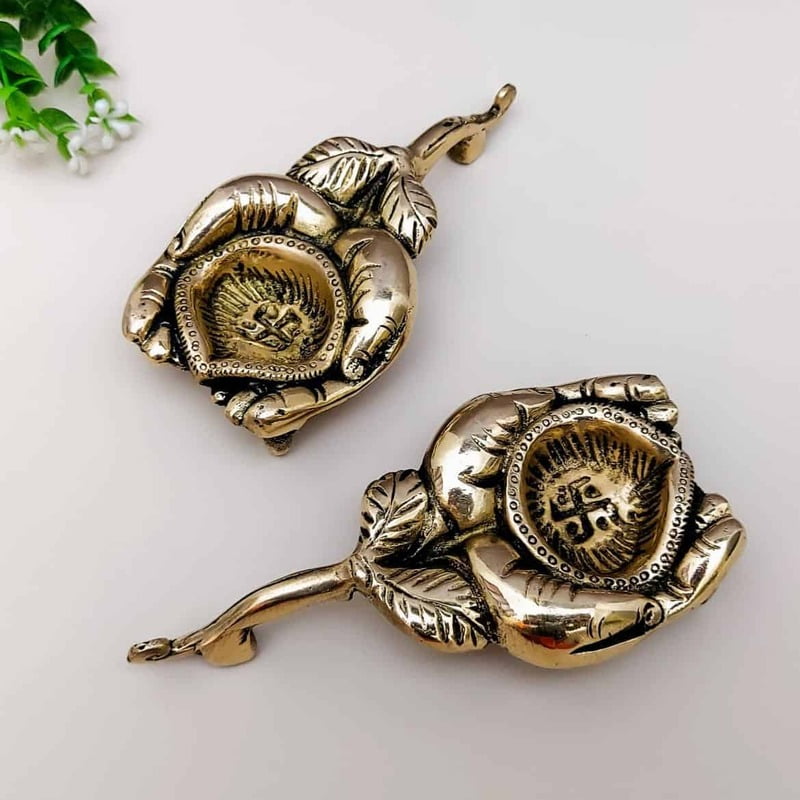 Brass Diya holding in Hands - 1 inch Height | Elegant Brass Diya held in Hands for Lighting Brass Diya holding in Hands - 1 inch Height | Elegant Brass Diya held in Hands for Lighting