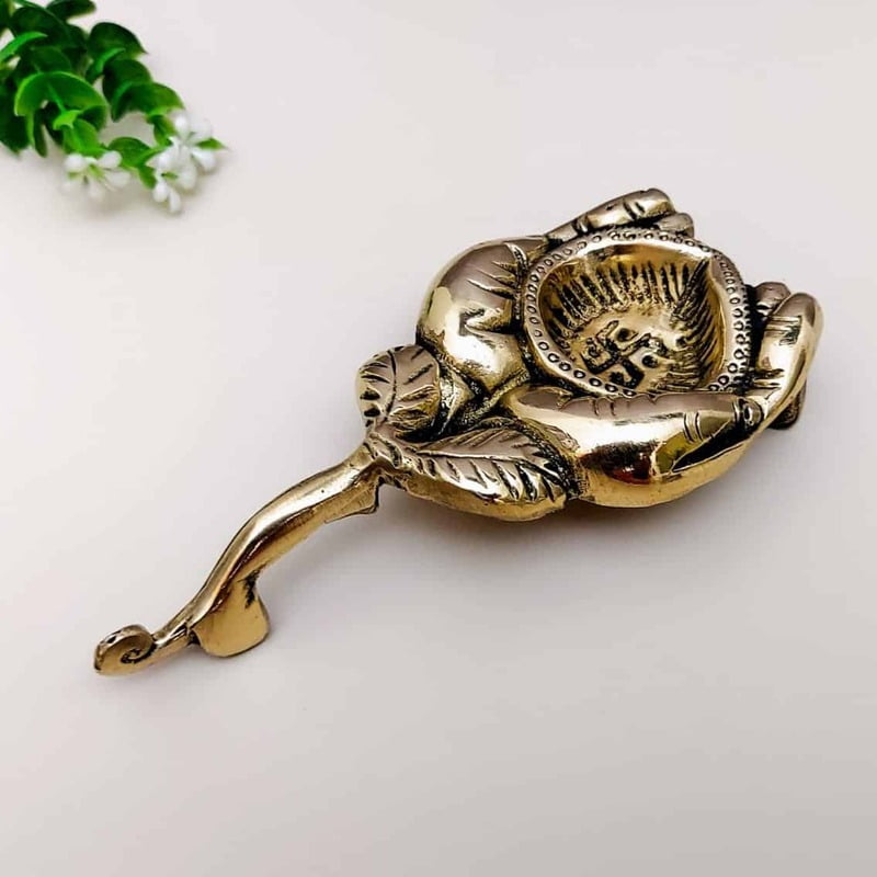 Brass Diya holding in Hands - 1 inch Height | Elegant Brass Diya held in Hands for Lighting Brass Diya holding in Hands - 1 inch Height | Elegant Brass Diya held in Hands for Lighting