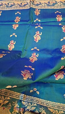 Blue green dual tone figure motif with heeran motif on the border with meena Baluchari saree