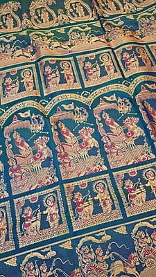 Blue green dual tone figure motif with heeran motif on the border with meena Baluchari saree